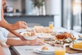 Hands, food and dinner on table for lunch preparation, meal or thanks giving time at home. Hand dishing healthy salad on Royalty Free Stock Photo