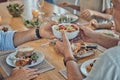 Hands, food and family with a group of people gathered around a dining room table for a meal or feast at home. Salad Royalty Free Stock Photo