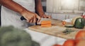 Hands, food and nutrition with a man cooking in the kitchen while cutting vegetables on a wooden chopping board. Salad Royalty Free Stock Photo