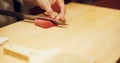 Hands, food and sushi chef cutting fish in restaurant for traditional Japanese cuisine or dish closeup. Kitchen, cooking Royalty Free Stock Photo