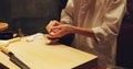 Hands, food and sushi chef in restaurant for traditional Japanese cuisine or dish closeup. Kitchen, cooking or seafood Royalty Free Stock Photo