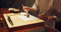 Hands, food and sushi with cook in restaurant for traditional Japanese cuisine or dish closeup. Kitchen, table for Royalty Free Stock Photo