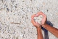 Hands in the form of heart with pebbles inside