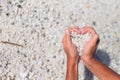 Hands in the form of heart with pebbles inside