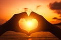 Hands forming a heart shape with sunset silhouette Royalty Free Stock Photo