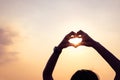 Hands forming a heart shape with sunset silhouette Royalty Free Stock Photo