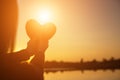 Hands forming a heart shape with sunset silhouette Royalty Free Stock Photo