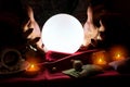 Hands of fortune teller with crystal ball in the middle Royalty Free Stock Photo