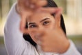 Hands, frame and eyes with a woman looking through her fingers while framing her face outdoor. Portrait, girl and happy Royalty Free Stock Photo