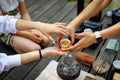 Hands of friends with Chinese teacup during the tea ceremony