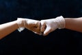 Hands of friends in medical gloves greeting each other with fist bump. Royalty Free Stock Photo