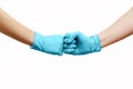 Hands of friends in medical gloves greeting each other with fist bump. Royalty Free Stock Photo