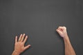 Hands in front of chalkboard