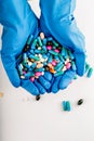 Hands full of medication. Tablets and pils Royalty Free Stock Photo