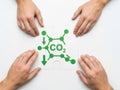 Hands gathered around a carbon dioxide molecule Royalty Free Stock Photo