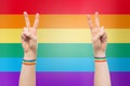 Hands with gay pride rainbow wristbands make peace Royalty Free Stock Photo