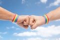 Hands with gay pride wristbands make fist bump Royalty Free Stock Photo