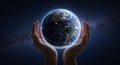 Hands gently cradle a digitally rendered Earth against a backdrop of space,