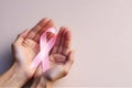 Hands gently holding a pink ribbon, symbolizing support and awareness for breast cancer Royalty Free Stock Photo