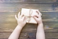 Hands, gift on a wooden background. surprise. Royalty Free Stock Photo