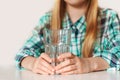 Hands of a girl close up, holding a glass of pure water Royalty Free Stock Photo