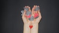 The hands of a girl full of different hearts