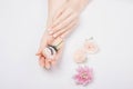 Hands girl master eyelash extension on white flowers background, top view. Beauty concept Royalty Free Stock Photo