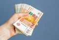 Russian, paper banknotes in their hands on a blue background Royalty Free Stock Photo