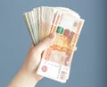 Russian, paper banknotes in their hands on a blue background Royalty Free Stock Photo