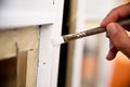 Hands of a girl painting a window