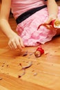 Hands of girl picking up smithereens of Christmas ball Royalty Free Stock Photo