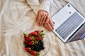 Hands girl with a plate of strawberries and blackberries in bed Royalty Free Stock Photo