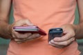 In the hands of a girl push-button old mobile phone and touch new phone close-up Royalty Free Stock Photo