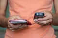 In the hands of a girl push-button old mobile phone and touch new phone close-up Royalty Free Stock Photo