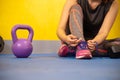 The hands of a girl`s shoelace and sneakers in the gym are ready Royalty Free Stock Photo