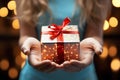Hands of girls clasp time gifts, enclosing a meaningful present box. Memory keepers. Royalty Free Stock Photo