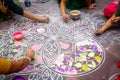 Hands of girls making rangoli - indian mandala. Indian tourism. Indian traditional culture, art and religion. decorative