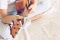 Hands girls play the guitar. A child learns to play the guitar. Selective focus. Close-up. The concept of music and art Royalty Free Stock Photo