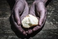 Hands give bread. Dirty hands asking for food. Sharing hope