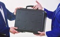 Hands give briefcase for exchange or offer bribe. Business transfer concept. Male hand hold briefcase. Handover of case Royalty Free Stock Photo