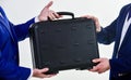 Hands give briefcase for exchange or offer bribe. Business transfer concept. Male hand hold briefcase. Handover of case Royalty Free Stock Photo