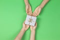 Hands give presents boxes over light green background. Christmas, New Year, holidays, birthday concept Royalty Free Stock Photo