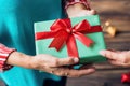 Hands giving and receiving present. Male and female hands holding gift box on blurred background Royalty Free Stock Photo