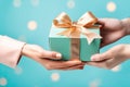 Hands giving and receiving present. Male and female hands holding gift box on blurred background Royalty Free Stock Photo