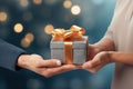 Hands giving and receiving present. Male and female hands holding gift box on blurred background Royalty Free Stock Photo