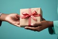Hands giving and receiving present. Male and female hands holding gift box on blurred background Royalty Free Stock Photo