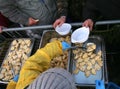 Hands giving and taking the dumplings during Christmas Eve for the poor and the homeless Royalty Free Stock Photo
