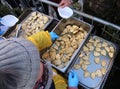 Hands giving and taking the dumplings during Christmas Eve for the poor and the homeless Royalty Free Stock Photo