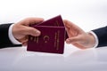 Hands giving and taking International Passport of a citizen of the Turkey for travel and border crossing