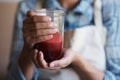 Hands, glass and juice with kitchen, closeup and person with smoothie for health and wellness. Chef, drink and beverage